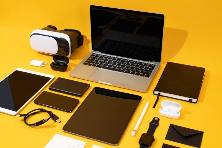 A laptop, phone, tablet, and other devices on a yellow background, representing the collaboration of We2usat K3 Pro and vSeeBox V3 Plus.