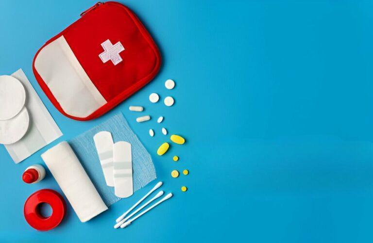 Blue background featuring a pediatric first aid kit, including antibiotics for any travel-related medical needs.