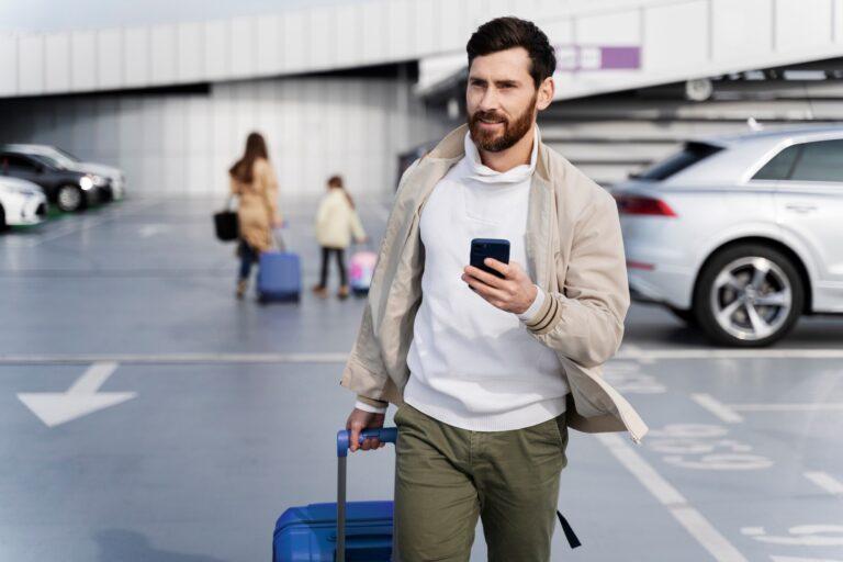 An airport scene features a man with a suitcase and phone, planning his transportation for a business trip in North Carolina.