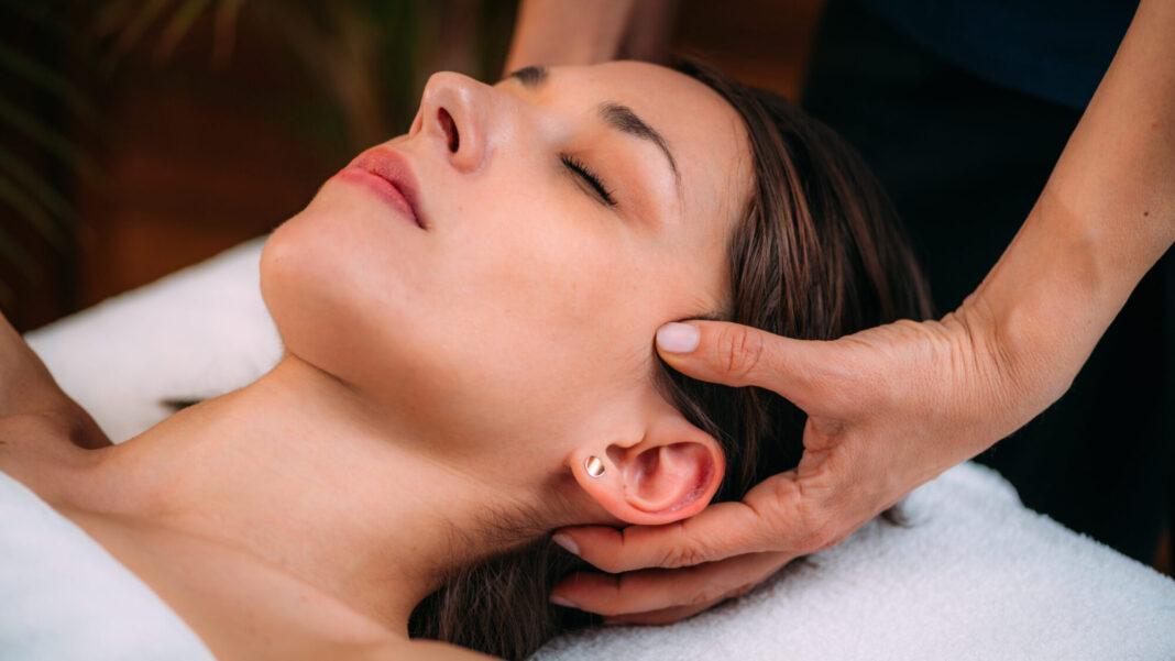 Cranial Osteopathy. Therapist Massaging Woman’s Head. craniosacral massage therapy Greenwood Village CO