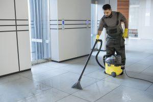full shot man vacuuming office floor 1 Soft Washing Services in Toronto: Safe Clean for Home and Roof
